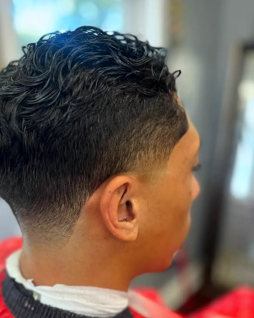 A curly taper with a clean neckline, seen from behind